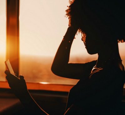 Alyssa uses phone near window