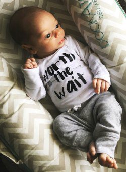 Gus wearing his 'worth the wait' onesie
