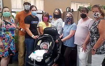 Seth, Mary, and baby Amilia visit Lifetime's staff